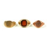 THREE VINTAGE 9CT GOLD GENT'S SIGNET RINGS One set with carnelian stone. Plain form (size R).