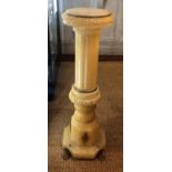 AN EARLY 20TH CENTURY CARVED ALABASTER COLUMN Applied with gilt metal mounts, on lion paw feet. (