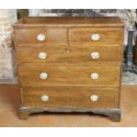 A GEORGIAN MAHOGANY AND SATINWOOD BANDED CHEST OF TWO SHORT ABOVE THREE LONG DRAWERS Fitted with