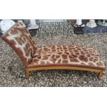A GIRAFFE SKIN UPHOLSTERED DAYBED On a honey oak base, supported on square splayed legs. (142cm x