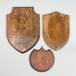 TWO LATE 19TH CENTURY WOODEN SHIELDS AND ONE LATER. Largest (h 39cm x w 28cm)