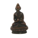 A CHINESE BRONZE BUDDHA Seated pose holding a bowlon lotus base. (approx 9cm)