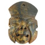 WITHDRAWN A CHINESE CARVED SOAPSTONE MASK, AN ARCHAIC FORM GROTESQUE FACE WITH PIERCED MOUTH AND