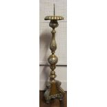 A LARGE CONTINENTAL BRASS PRICKET CANDLESTICK Having engraved floral decoration and scrolled, on