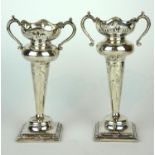 A PAIR OF EARLY 20TH CENTURY SILVER FLOWER VASES Having twin handles and pierced decoration on