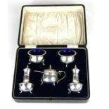 AN EARLY 20TH CENTURY SILVER FIVE PIECE CONDIMENT SET Comprising two circular salts and a mustard