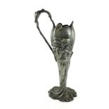 AN ART NOUVEAU CONTINENTAL PEWTER TWIN HANDLED VASE Organic form with mask handles and embossed