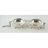 A PAIR OF EARLY 20TH CENTURY SILVER SWEETMEAT CIRCULAR DISHES Twin ribbon handles, on four legs. (