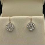 A PAIR OF 18CT WHITE GOLD STUD EARRINGS cluster set with .48ct diamonds .6cm