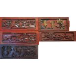 A COLLECTION OF FIVE CHINESE CARVED SOFTWOOD PANELS Comprising a figural panel with gilt finish on