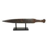 A RARE GREEK ARCHAIC IRON SWORD, CIRCA 600BC With tapering fullered blade, on museum display