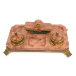 AN EARLY 20TH CENTURY GILT BRASS AND ROUGE MARBLE RECTANGULAR DESK STAND With two circular