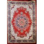 A LARGE INDIAN PLUSH VELVET RUG OF CARPET PROPORTIONS The central floral field on a wine red