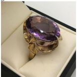 A VINTAGE 1960'S 9CT GOLD DRESS RING set with large amethyst size L