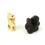 TWO 19TH CENTURY JAPANESE CARVED WOOD AND IVORY NETSUKE Dragon with entwined tail and a coiled