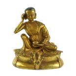 A CHINESE GILT BRONZE BODHISATTVA BUDDHA In a pensive seated pose with one arm raised and a