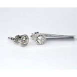 A PAIR OF 18CT WHITE GOLD AND DIAMOND 'HALO' STUD EARRINGS Each set with a round cut diamond,