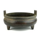 A CHINESE BRONZE TWIN HANDLED CENSOR Raised on three squat legs, bearing a six character mark. (