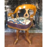 A VICTORIAN MAHOGANY HOOPED BACK REVOLVING CAPTAIN'S CHAIR With pierced rails and saddle seat,