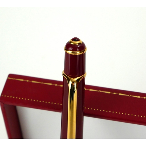 CARTIER, A CASED FULL SIZE GOLD PLATED STYLO DIABOLO BALLPOINT PEN Bordeaux finish with cabochon cut - Image 3 of 3