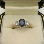 AN 18CT GOLD RING set with 1.80ct sapphire flanked by diamonds size P/Q