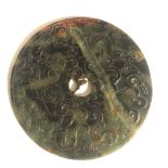 A CHINESE GREEN JADE BI Carved with dragons and beasts. (diameter 15cm)