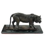 A BRONZE STATUE OF A TIGER On a black marble base. (51cm x 23cm)