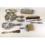 A RARE TEN PIECE ART NOUVEAU STERLING SILVER VANITY BRUSH AND COMBE SET Comprising a hand mirror,