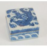 A CHINESE BLUE AND WHITE PORCELAIN SQUARE TRINKET BOX Painted decoration, dragon chasing a flaming