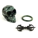 A CARVED GREEN HARDSTONE SKULL PAPERWEIGHT Having a pierced jaw, together with a Chinese carved jade