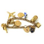 A VINTAGE 9CT GOLD CHARM BRACELET With tapering rose gold Albert bracelet set with ten 9ct yellow