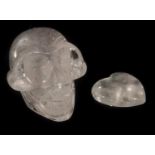 A CARVED AND POLISHED ROCK CRYSTAL SCULPTURE OF A HUMAN SKULL Along with a rock crystal heart. (