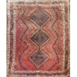 AN IRANIAN WOOLLEN RUG Three central lozenges contained within four running borders. (approx 260cm x
