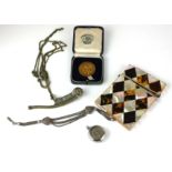 A COLLECTION OF VICTORIAN AND LATER WHITE METAL TRINKETS Comprising an Albert watch chain, a