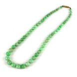 A VINTAGE 9CT GOLD AND CHINESE JADE NECKLACE Having a row of graduating spherical beads with a 9ct