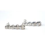 A PAIR OF 18CT WHITE GOLD AND DIAMOND DROP EARRINGS Having a single row of graduating round cut