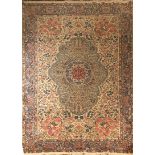 AN IRANIAN KIRMAN LAVER TORANG WOOLLEN RUG The central lozenge contained within a floral field