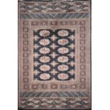 A PERSIAN BOKHARA WOOLLEN RUG With twelve geometric designs to central field with running borders on