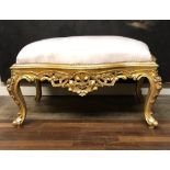 A FRENCH DESIGN GILT WOOD AND UPHOLSTERED WINDOW SEAT Cartouche form with pierced floral apron,