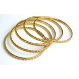 A COLLECTION OF FIVE CONTINENTAL YELLOW METAL BANGLES Having spherical form design. (approx 7cm)