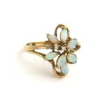 A VINTAGE 9CT GOLD, OPAL AND DIAMOND RING Having an arrangement of oval cut opals set with three