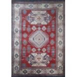 AN ANATOLIAN WOOLLEN RUG Three geometric form lozenges on a red and cream field. (approx 157 x