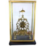 A LARGE PIERCED BRASS SKELETON CLOCK With fusée movement in glass and brass bound display case. (