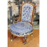 A VICTORIAN MAHOGANY NURSING CHAIR Blue floral button back fabric upholstery, on turned legs