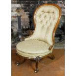 A VICTORIAN MAHOGANY SPOONBACK OPEN ARMCHAIR In button back green floral fabric upholstery. (50cm