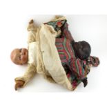 AN EARLY 20TH CENTURY COMPOSITION TOPSY TURVY DOLL Having reversible black and white dolls with