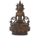 A TIBETAN GILT BRONZE LAKSHMI BUDDHA FIGURE Seated pose with elaborate headdress, on a lotus