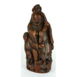 A 19TH CENTURY CARVED BAMBOO FIGURAL GROUP Standing Buddha with a smiling character holding a peach.