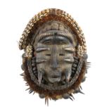 A COLLECTION OF FOUR 20TH CENTURY CARVED WOODEN AFRICAN TRIBAL ART MASKS Including a mask with