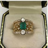 A VINTAGE 70'S GOLD RING set with 1.1ct emerald and .7ct diamonds on pierced band size Q